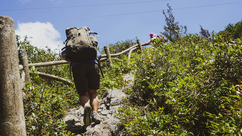 a man with a backpack walking up a hill