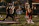 A serene outdoor yoga session with participants practicing Ayurveda-inspired breathing exercises.