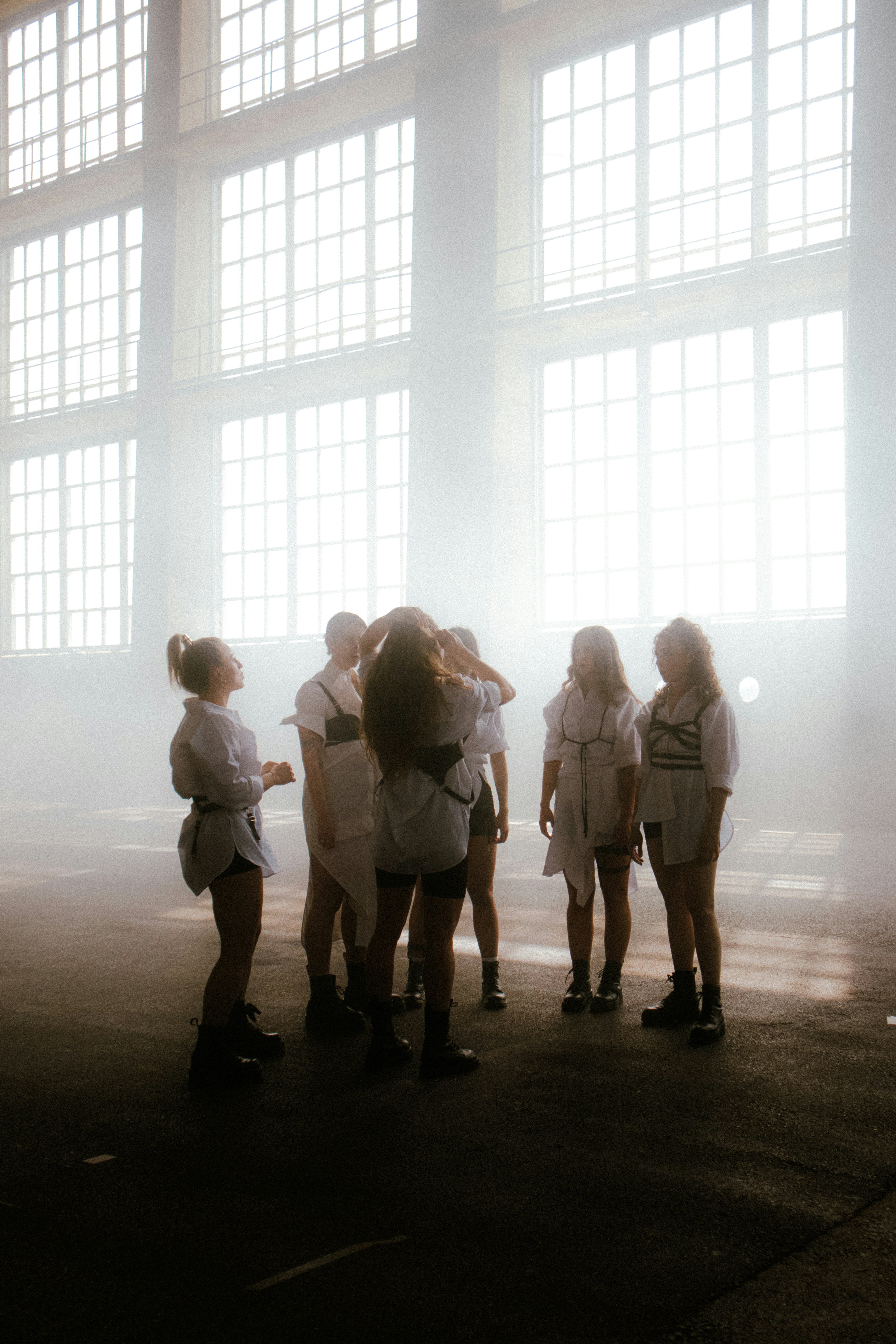 a group of people standing in front of a window