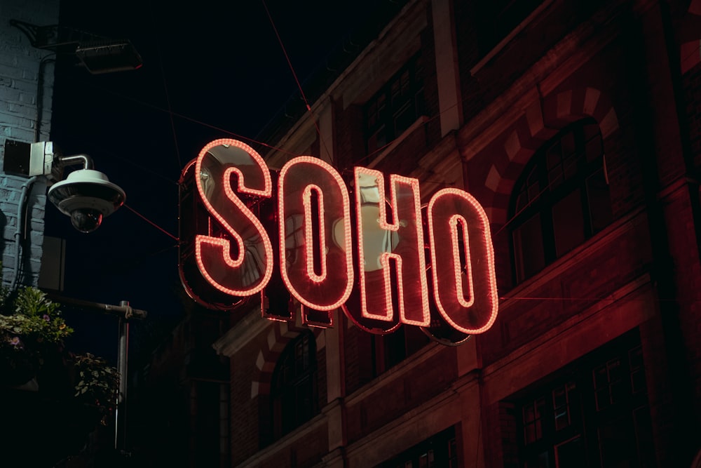 a neon sign that reads soph on the side of a building
