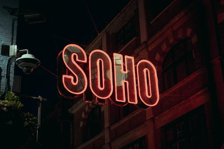 A red neon sign glowing on a brick building