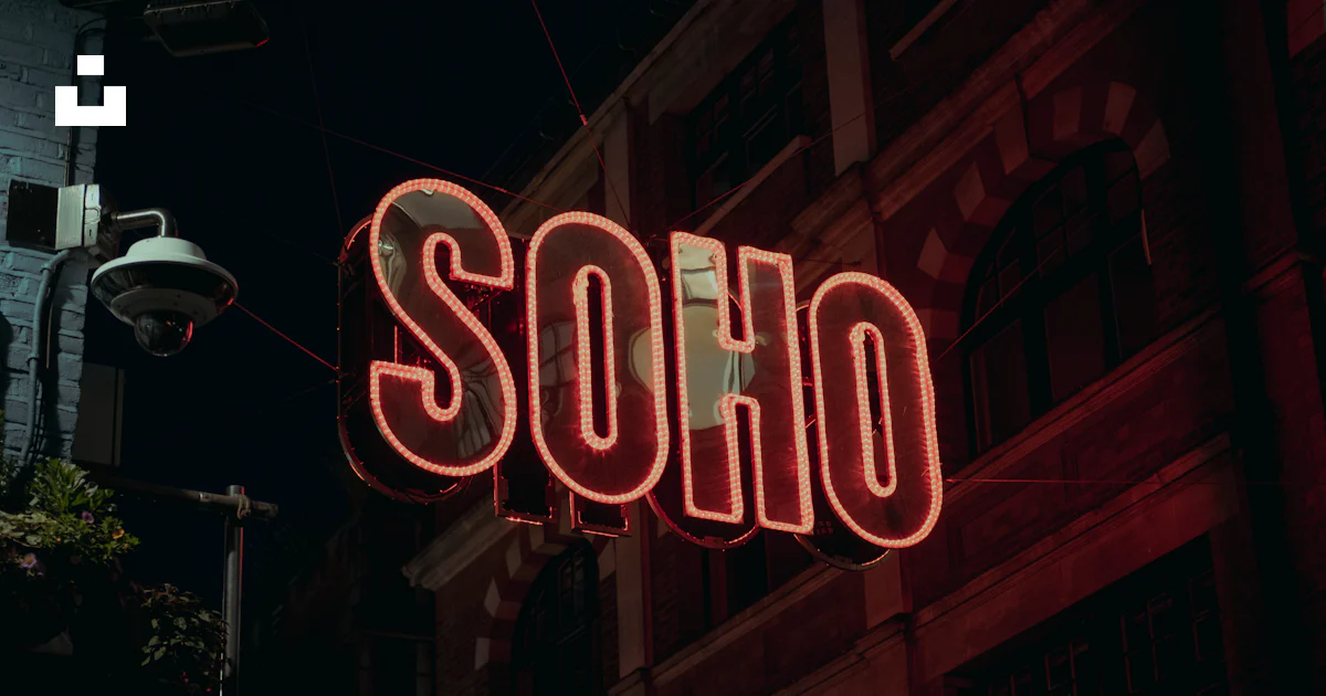 Soph Sign A neon sign that reads soph on the side of a building photo – Free Dark ...