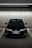 A black Honda car is parked in an indoor parking garage, lined with parking spaces and illuminated by overhead fluorescent lights. The concrete walls and ceiling create an industrial atmosphere.