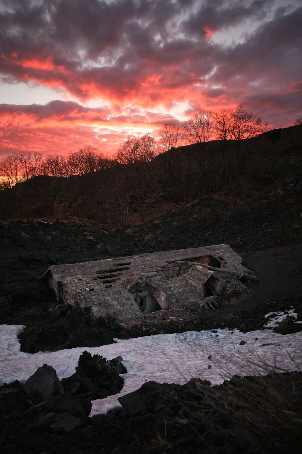 the sun is setting over the ruins of a building