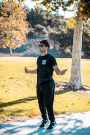 a man in a black shirt is flying a kite