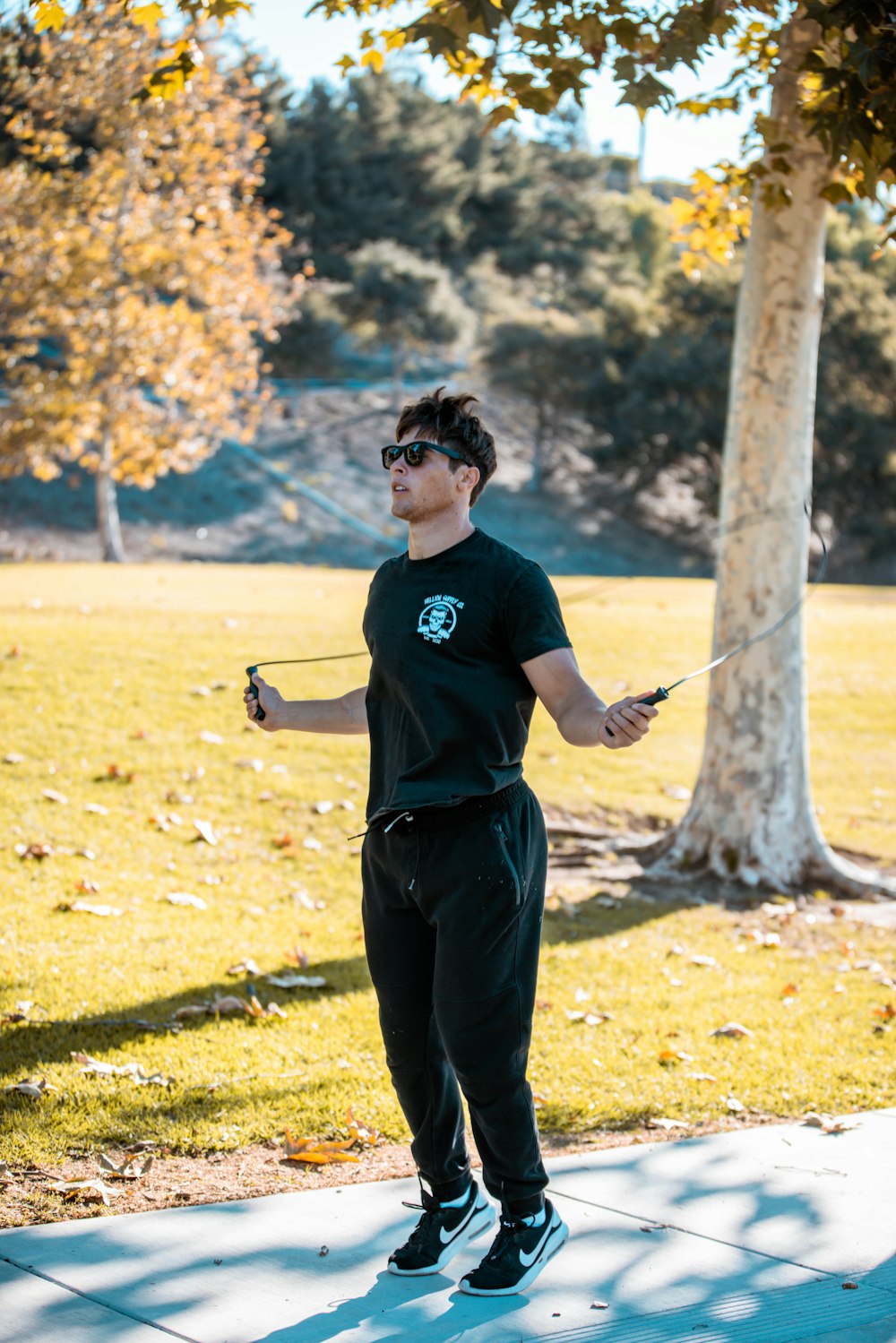 a man in a black shirt is flying a kite