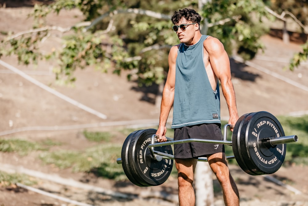 a man holding a barbell in his hands