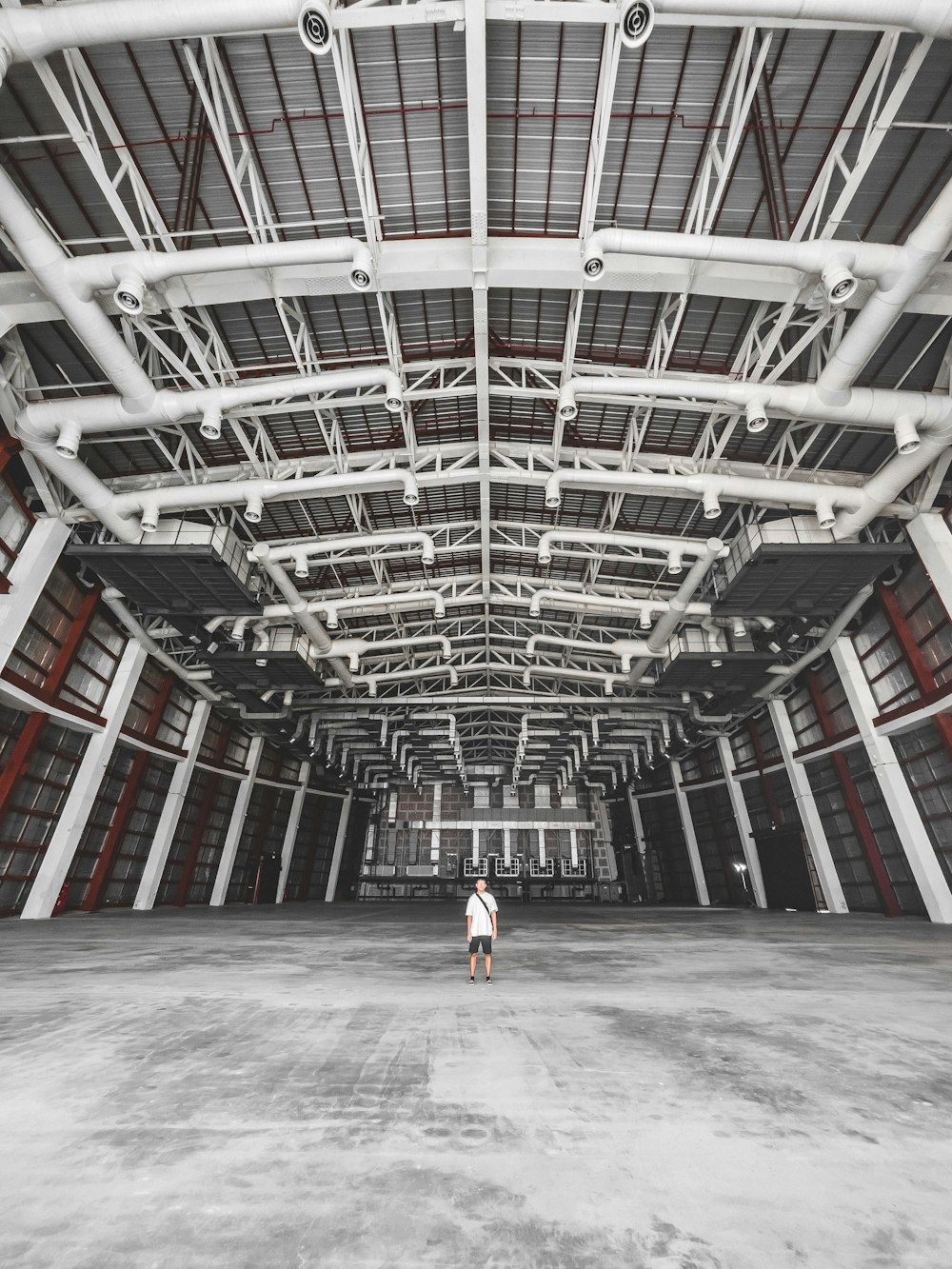 a woman is standing in a large building