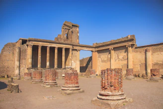 an old building with columns and a clock tower