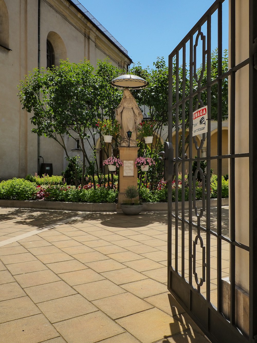 a gated entrance to a building with a fountain