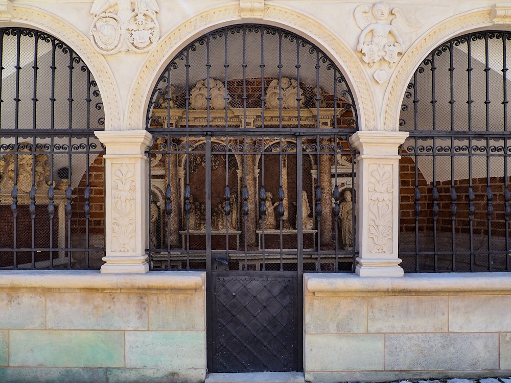 a gated entrance to a building with iron bars