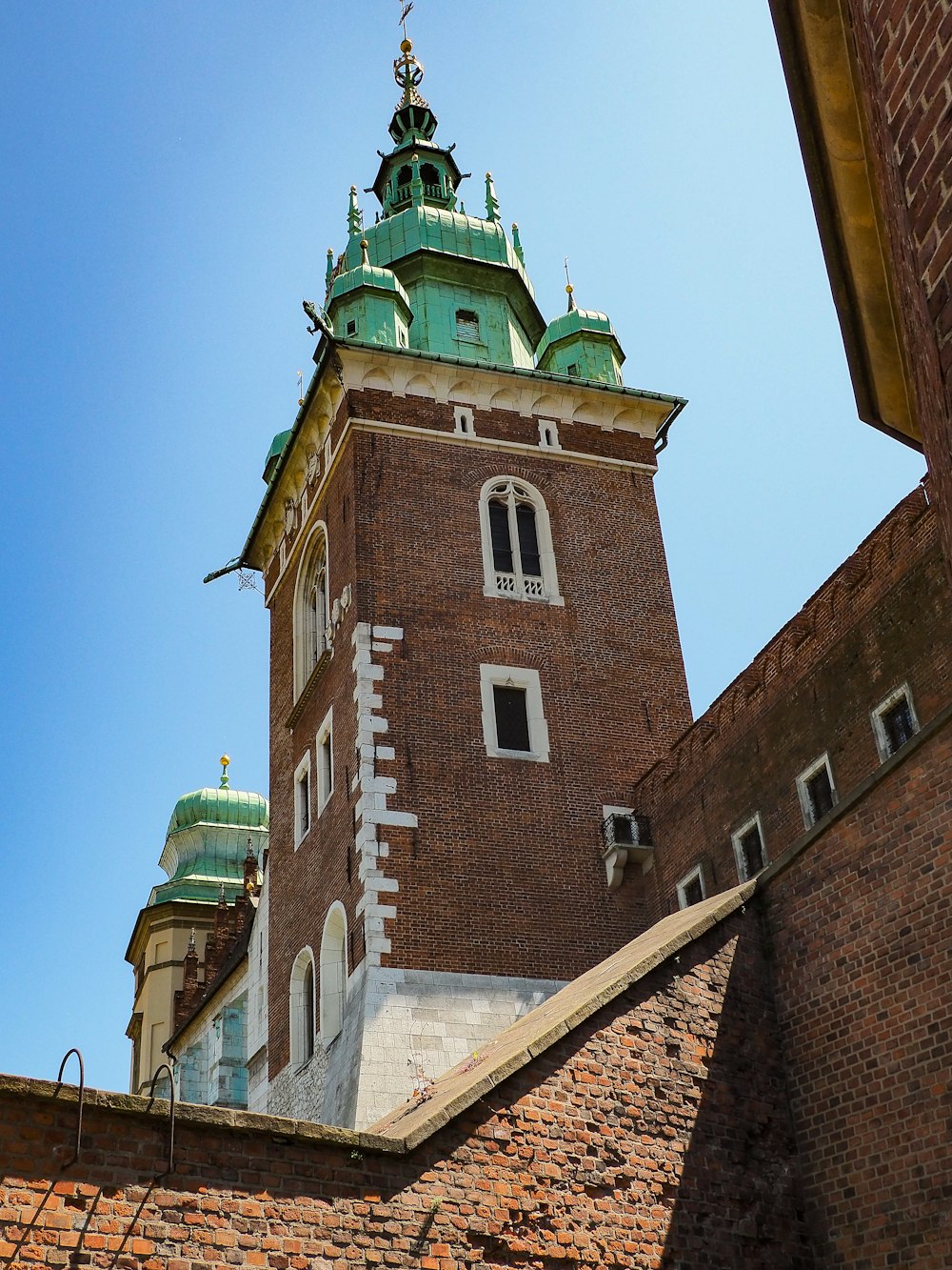 a tall brick tower with a clock on it's side