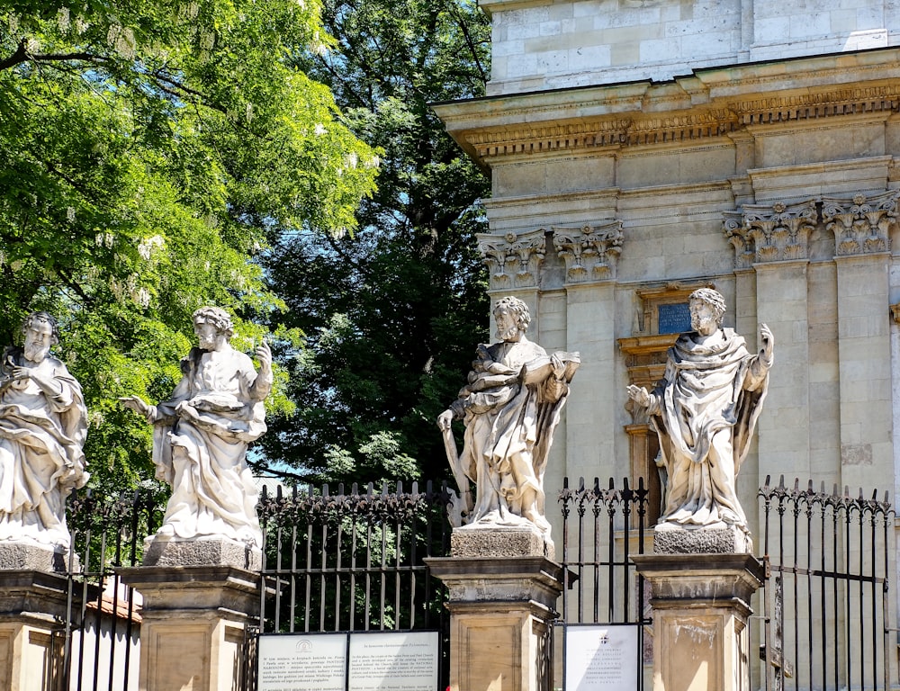 a group of statues in front of a building