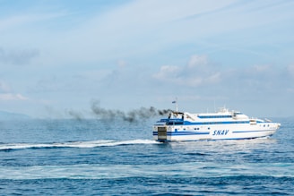 a boat with smoke coming out of it in the ocean