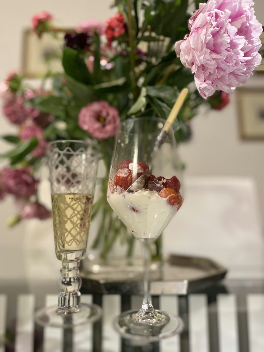 a table topped with two wine glasses filled with dessert