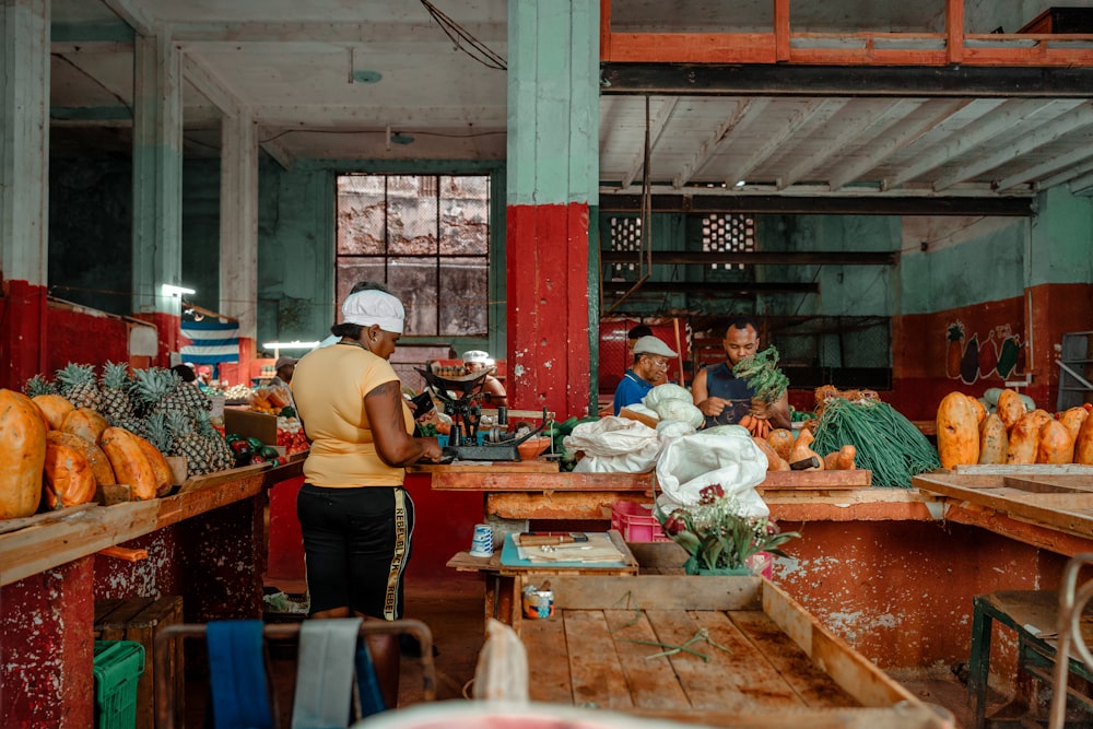 a group of people standing around a wooden table