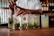 A bartender stirs a series of cocktails in tall glasses, each adorned with mint leaves and labeled with the Havana Club logo. The setting appears to be a dimly lit bar with bottles and a wooden counter.