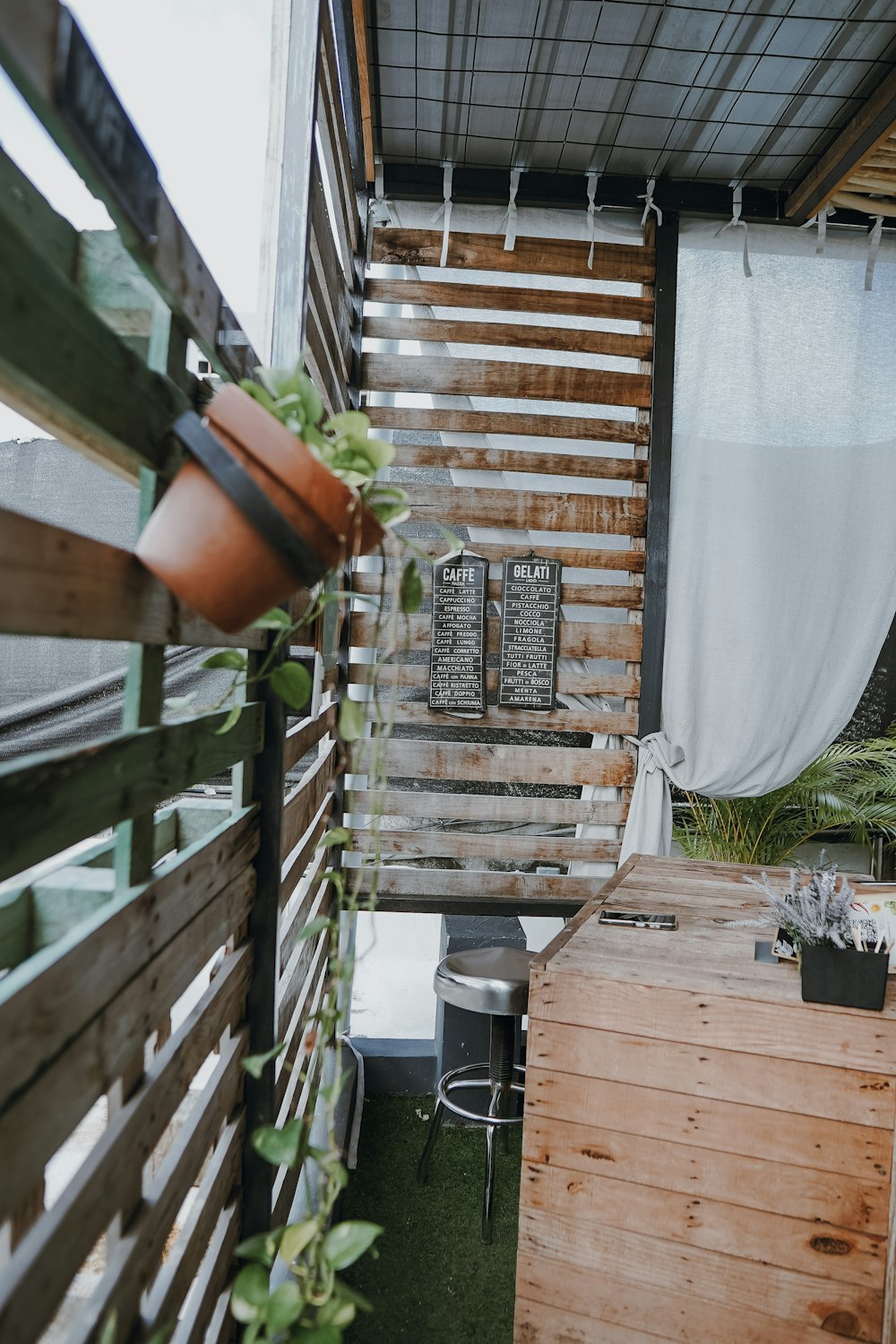 a wooden table sitting next to a wooden fence