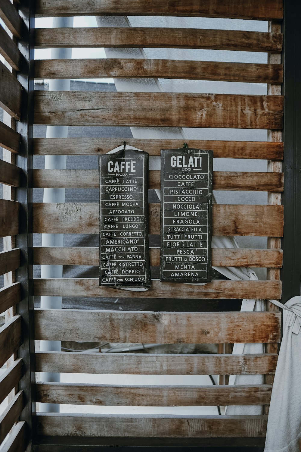 a wooden wall with two signs on it