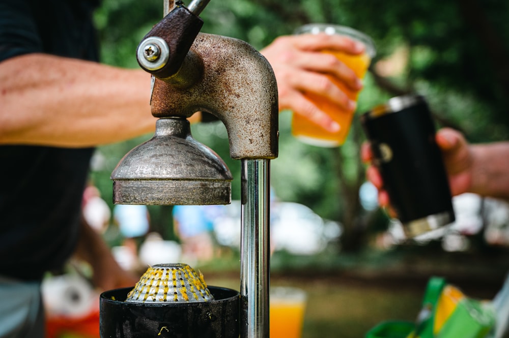 a close up of a person holding a beer