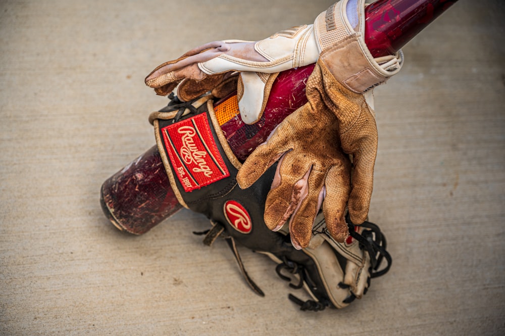 a baseball glove and glove on top of a baseball bat