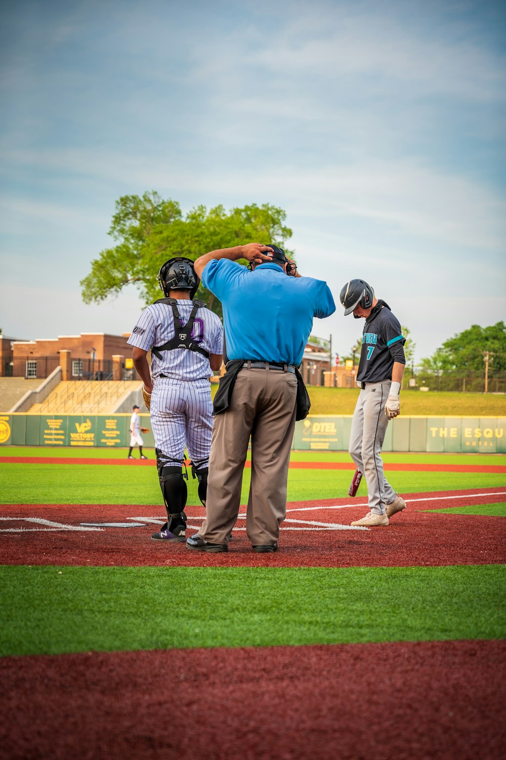 a group of men standing on top of a baseball field