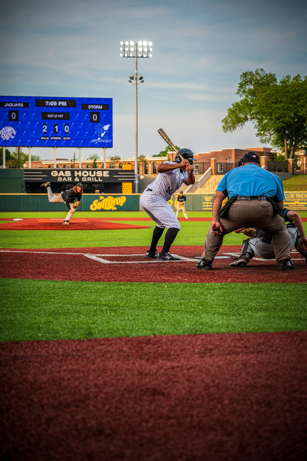 a baseball player holding a bat on top of a field