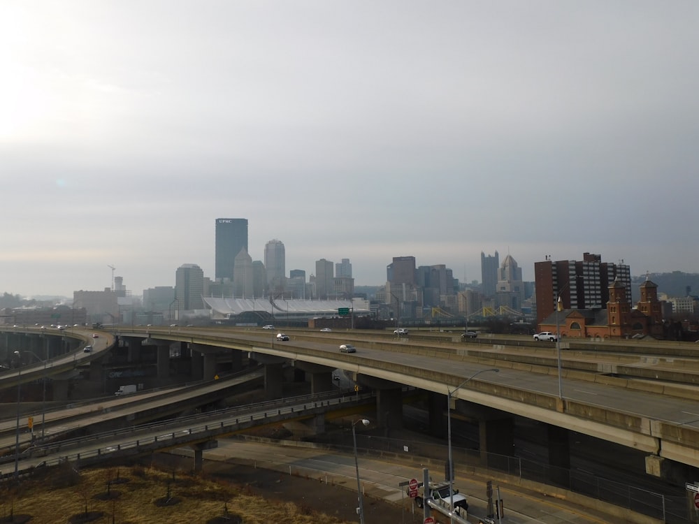 a freeway with a city skyline in the background