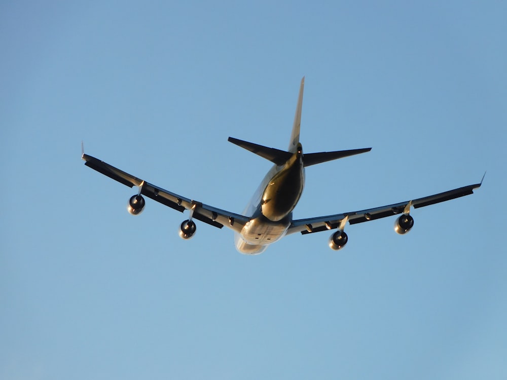 a large jetliner flying through a blue sky