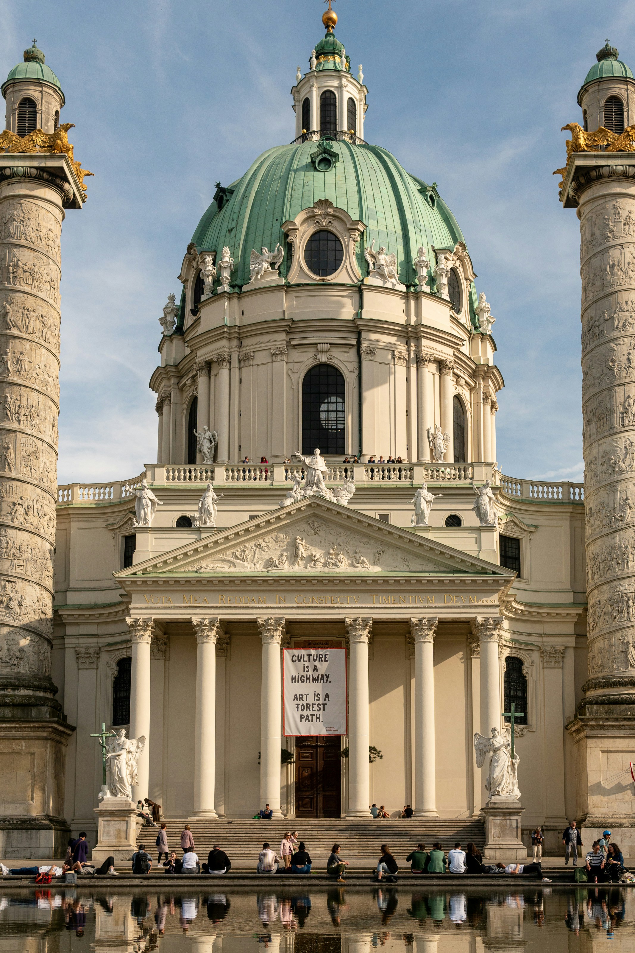 a large white building with a green dome