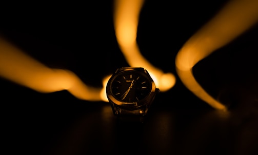 Artistic shot of a limited-edition watch face illuminated by soft spotlight.