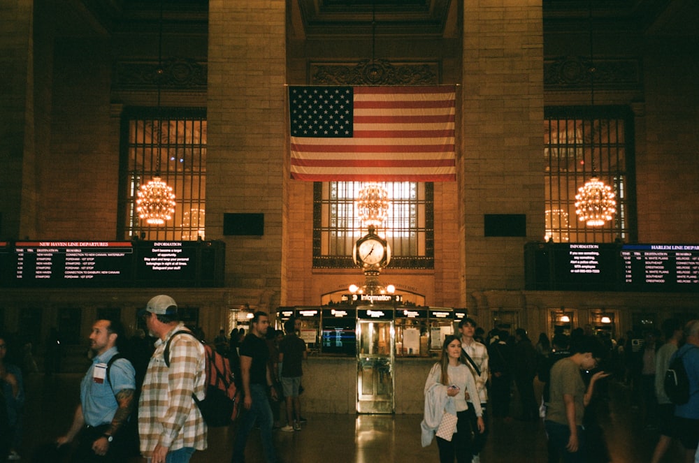 a group of people standing in front of an american flag