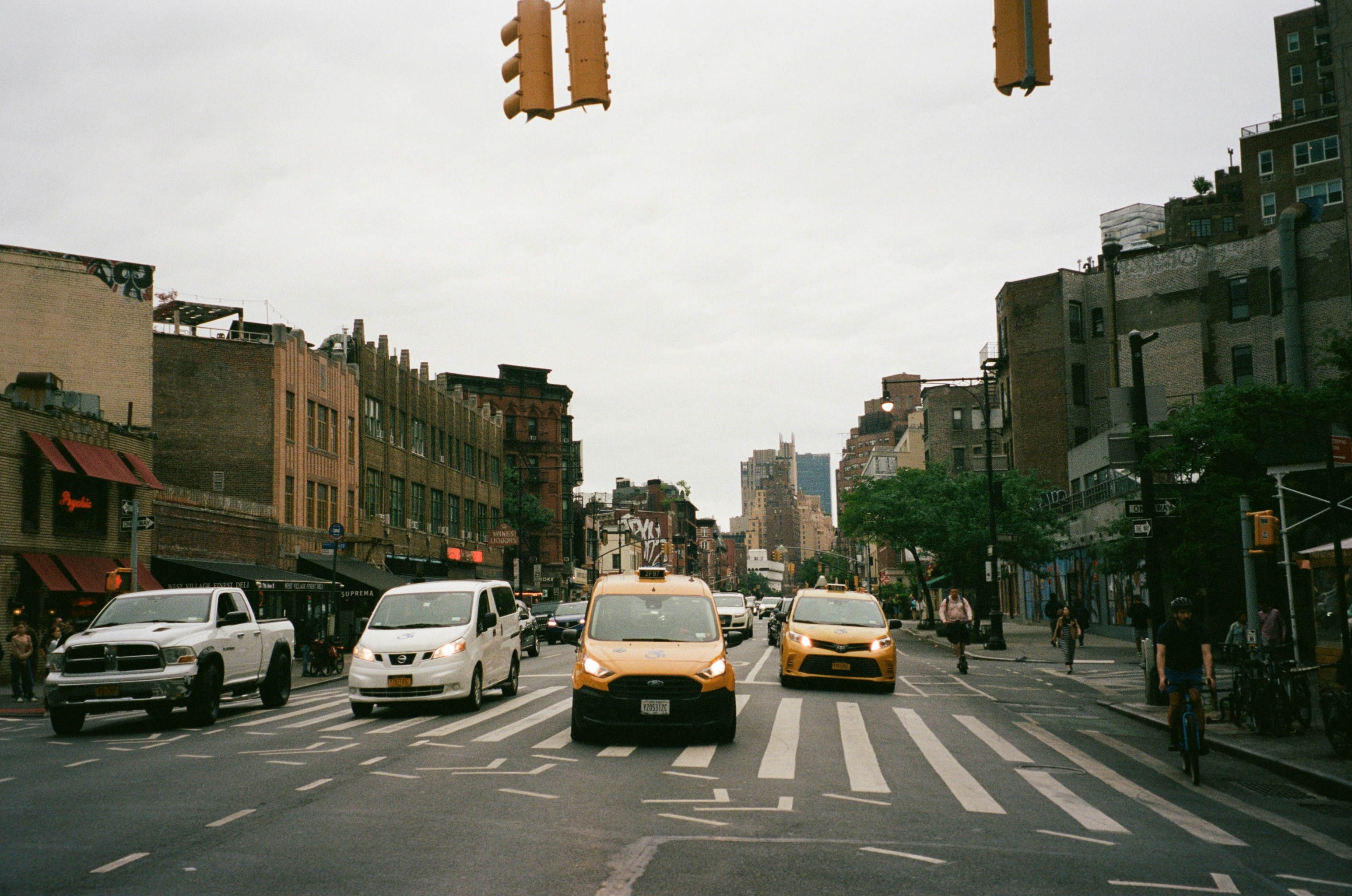 a city street filled with lots of traffic next to tall buildings