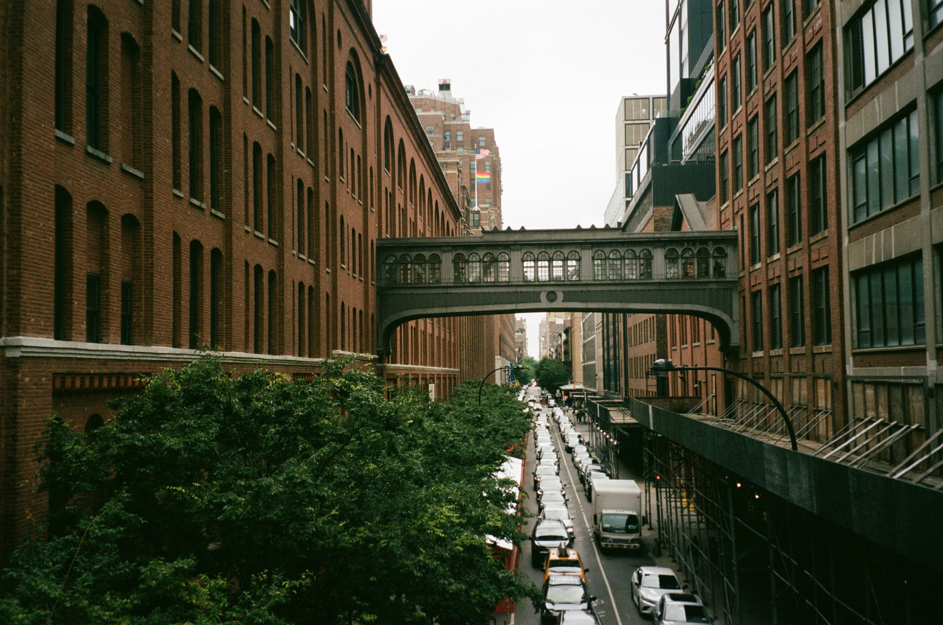 a city street filled with lots of traffic under a bridge