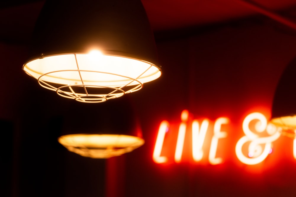 a neon sign that says live and love hanging from a ceiling