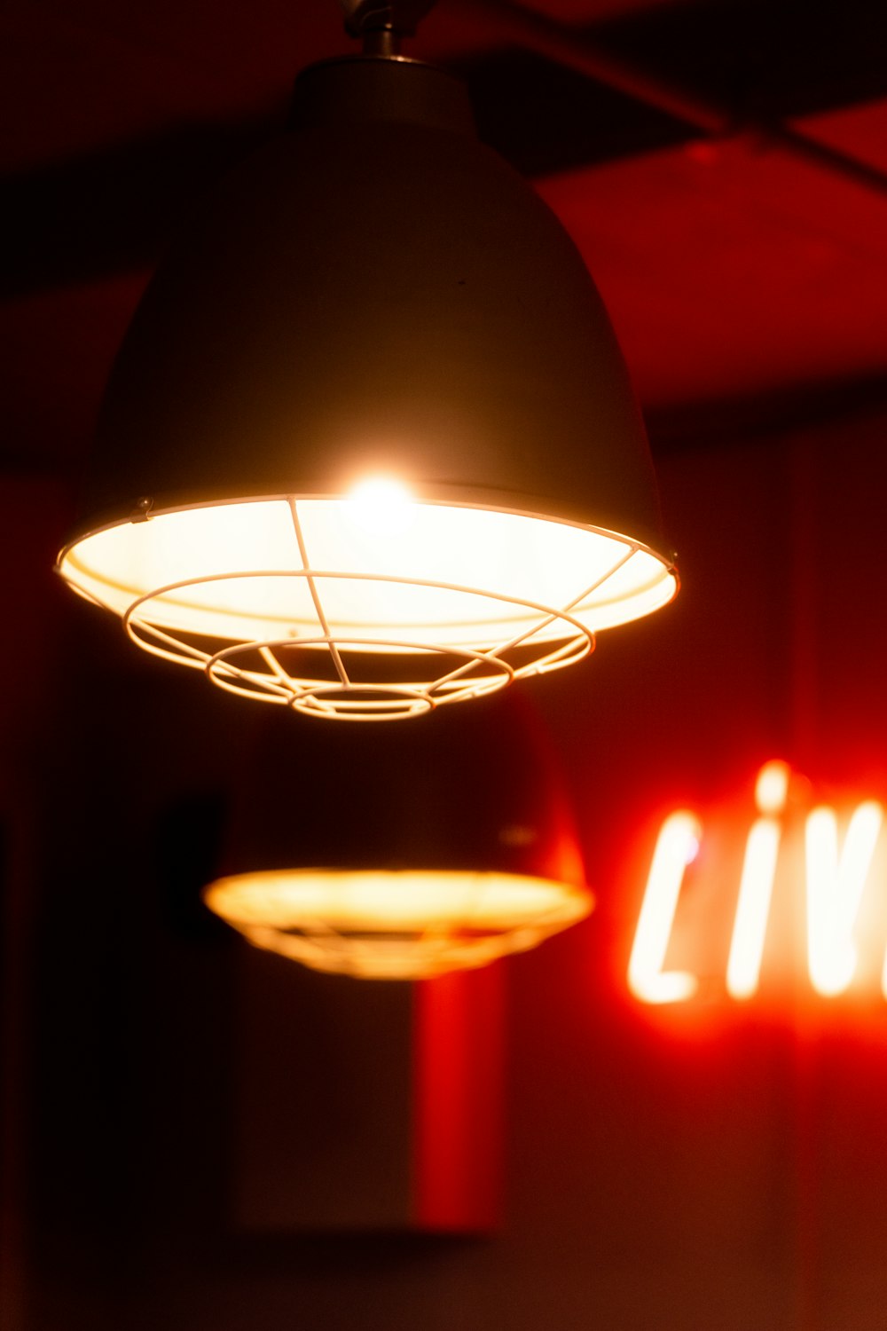 a red neon sign hanging from the ceiling of a room