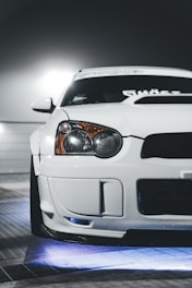 A close-up of a car featuring bright LED underglow lights.