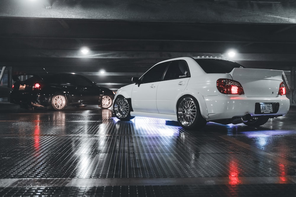 a white car parked in a parking garage