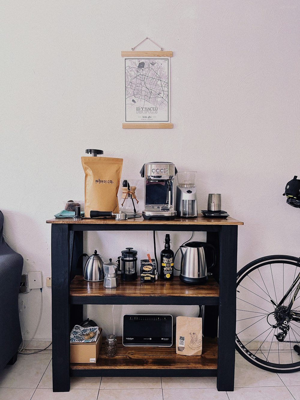 a table with a coffee maker, coffee pot, and other items on it