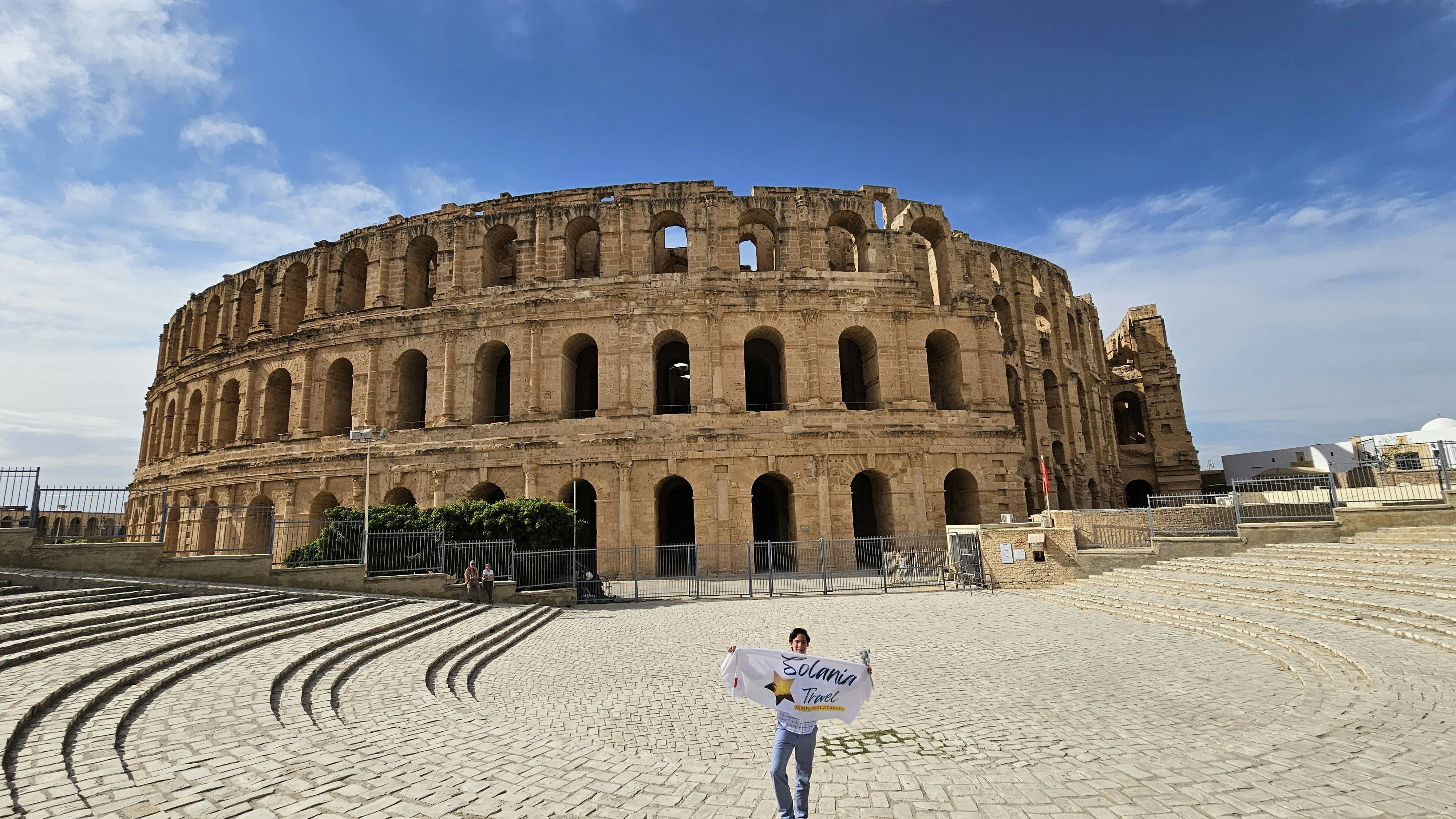 a man standing in front of a large building