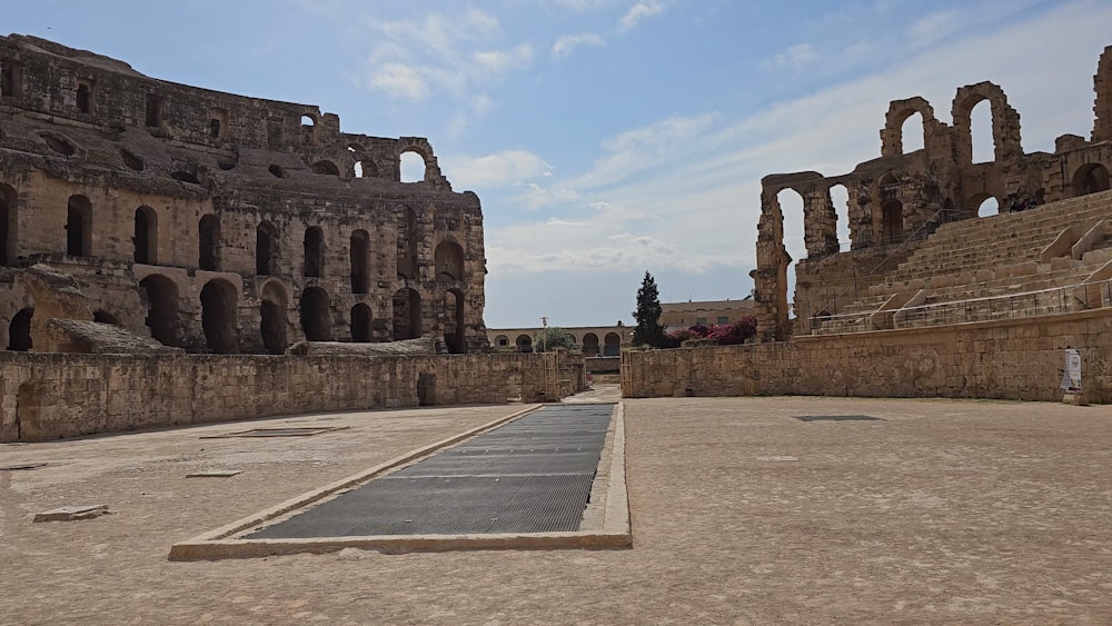 an empty parking lot with a stone building in the background