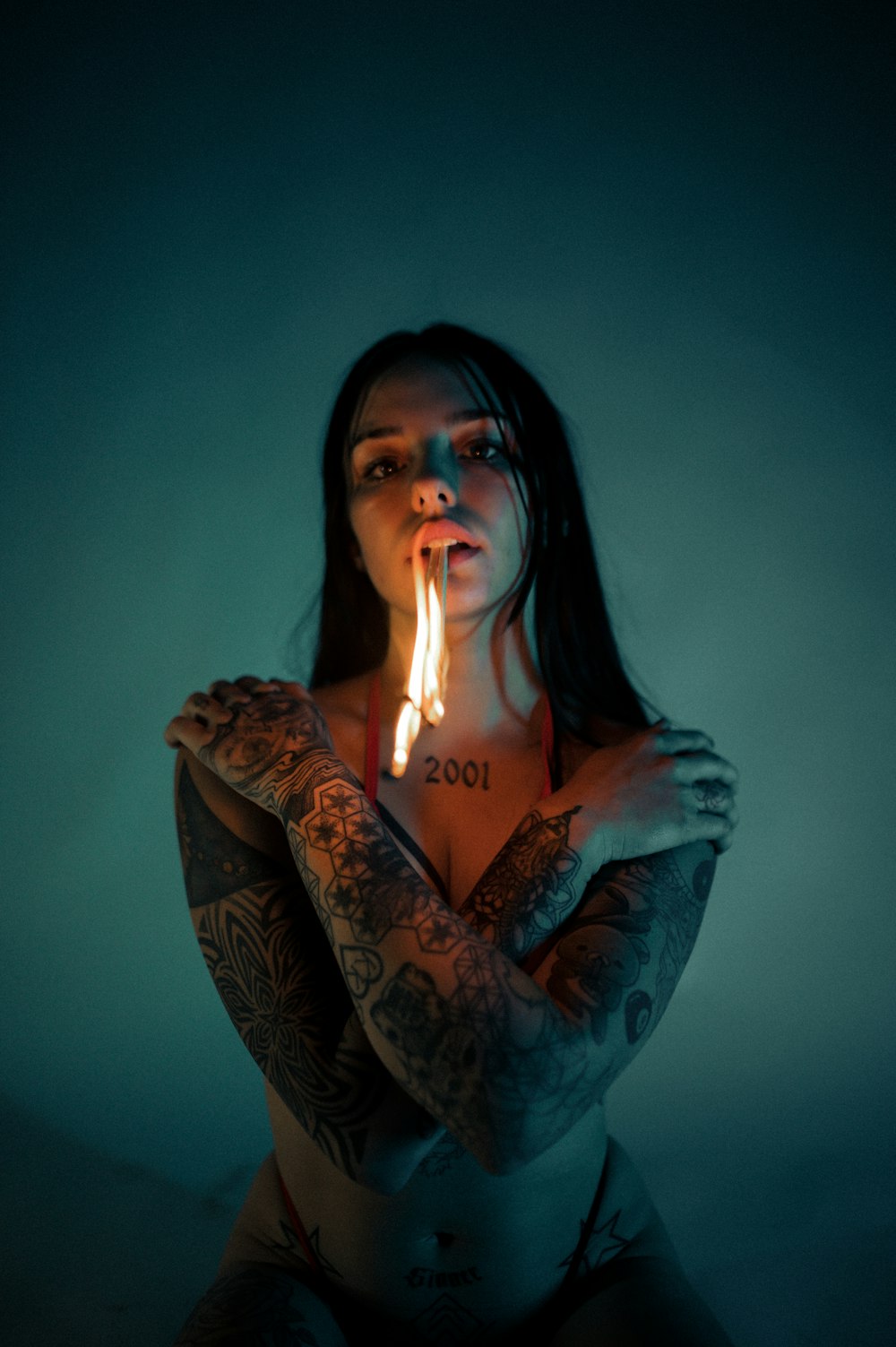 a woman holding a lit candle in her hand