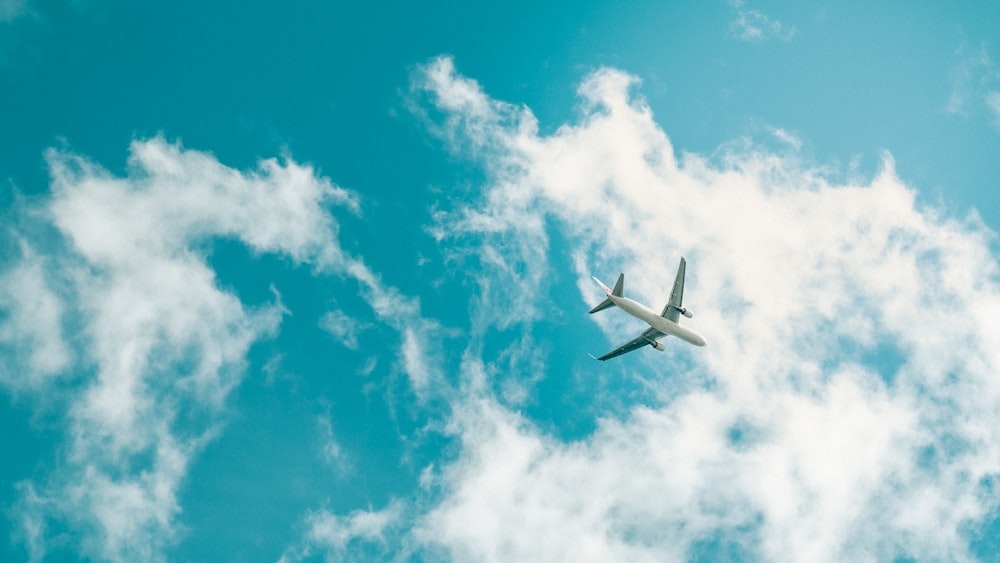 an airplane is flying through the blue sky