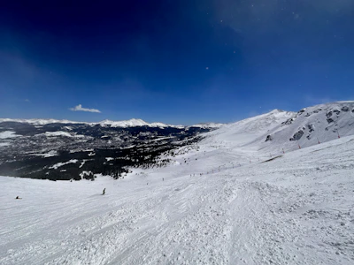Dynamic snowy mountain landscape with skiers enjoying winter sports.
