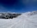 A scenic mountain backdrop with skiers enjoying fresh powder.