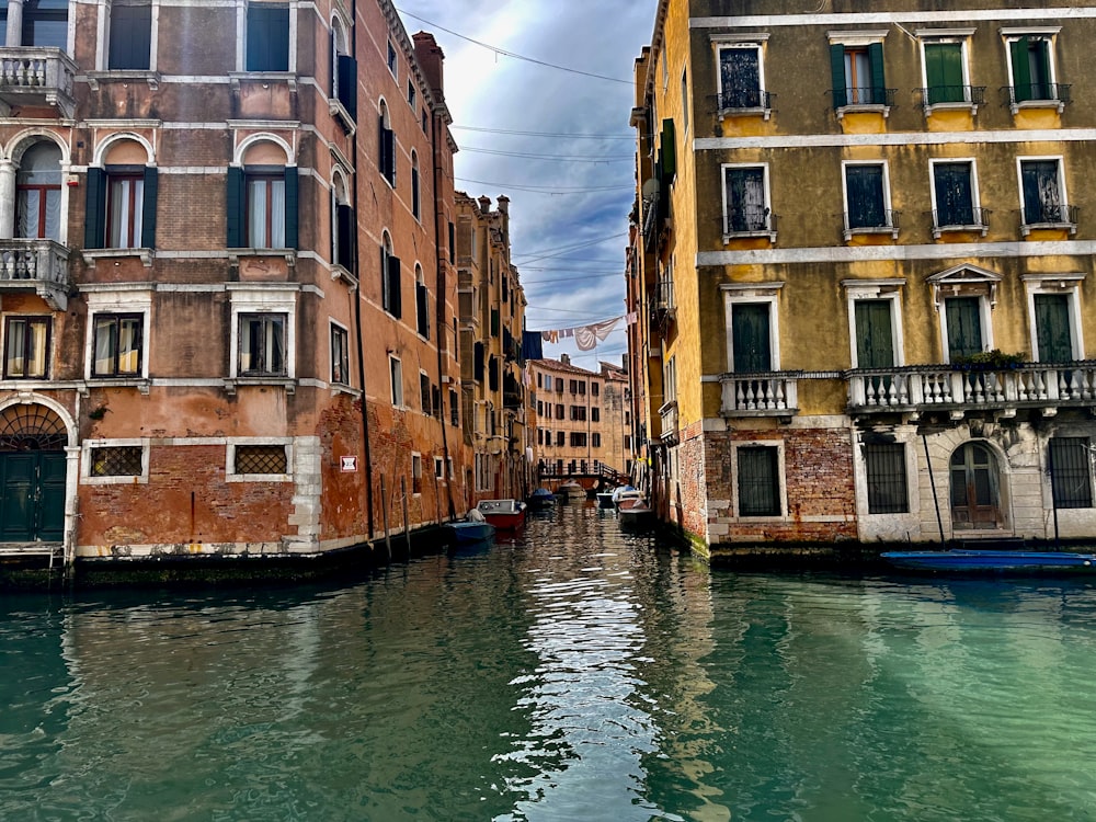 a canal with buildings and a boat in the water