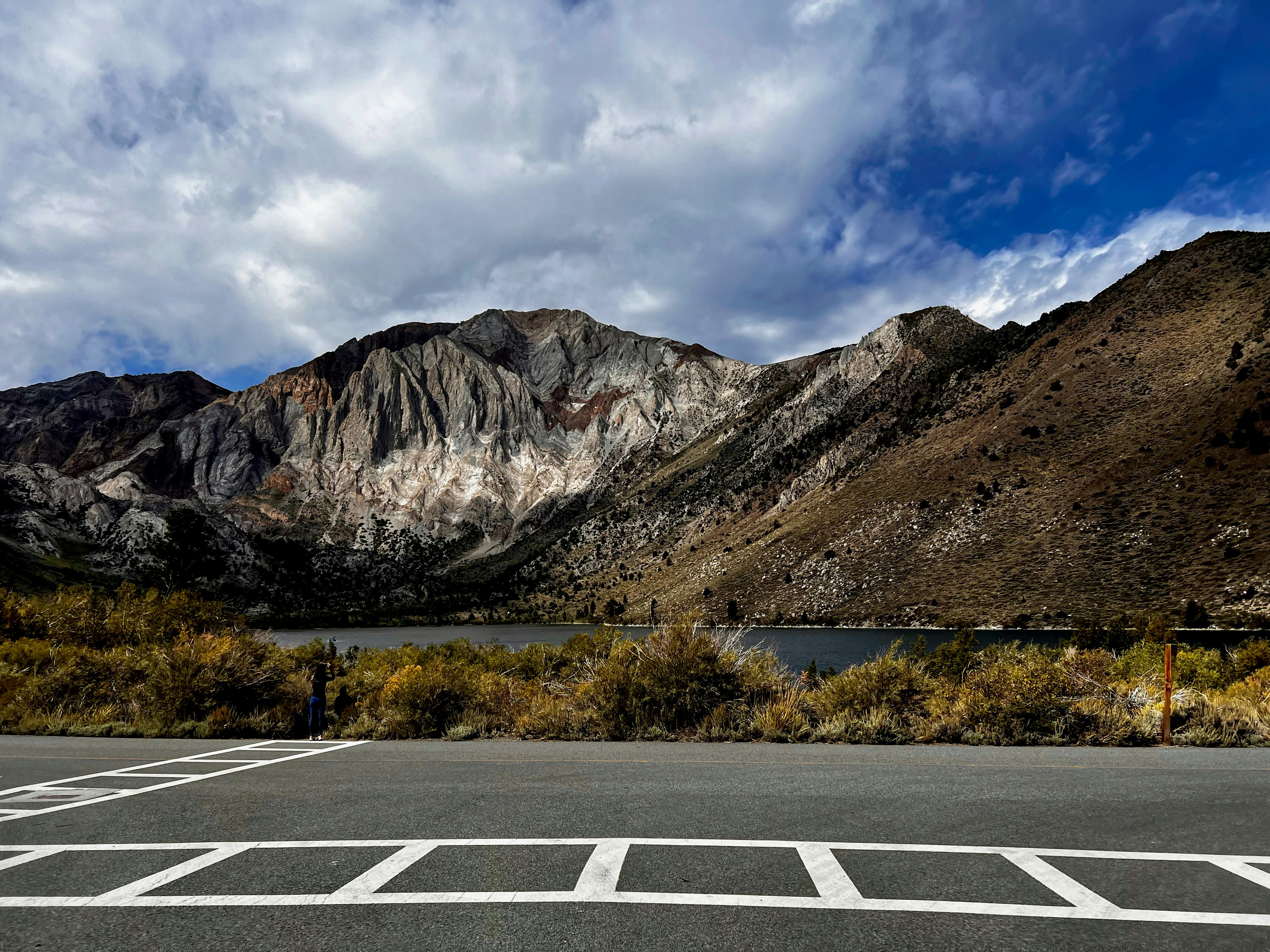 a parking lot in front of a mountain range