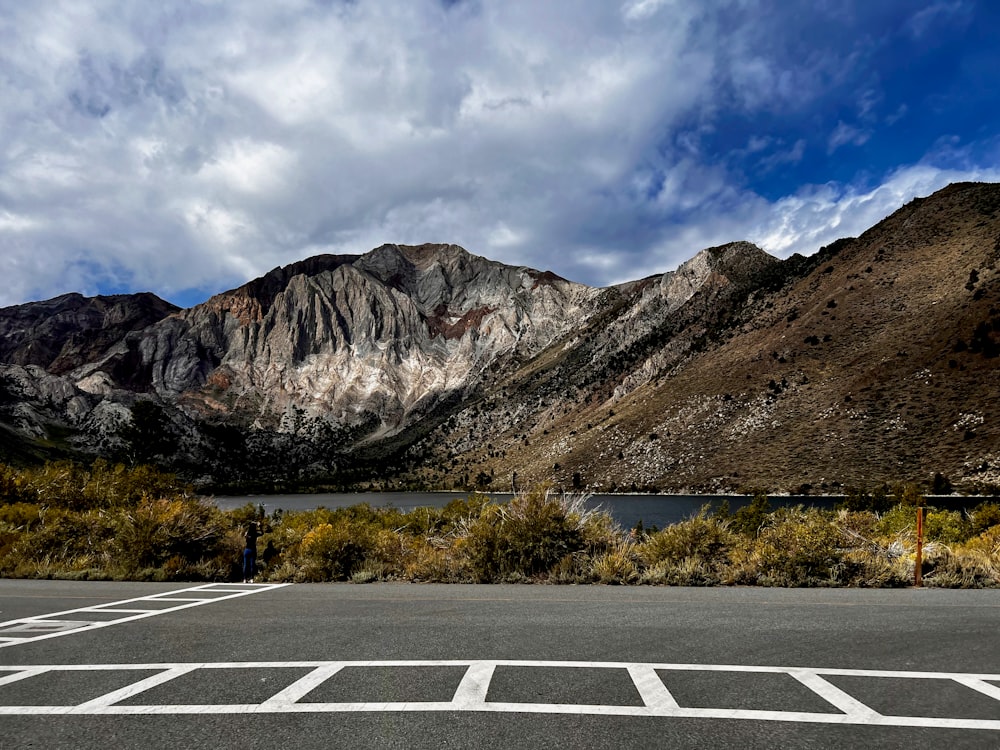 a parking lot in front of a mountain range