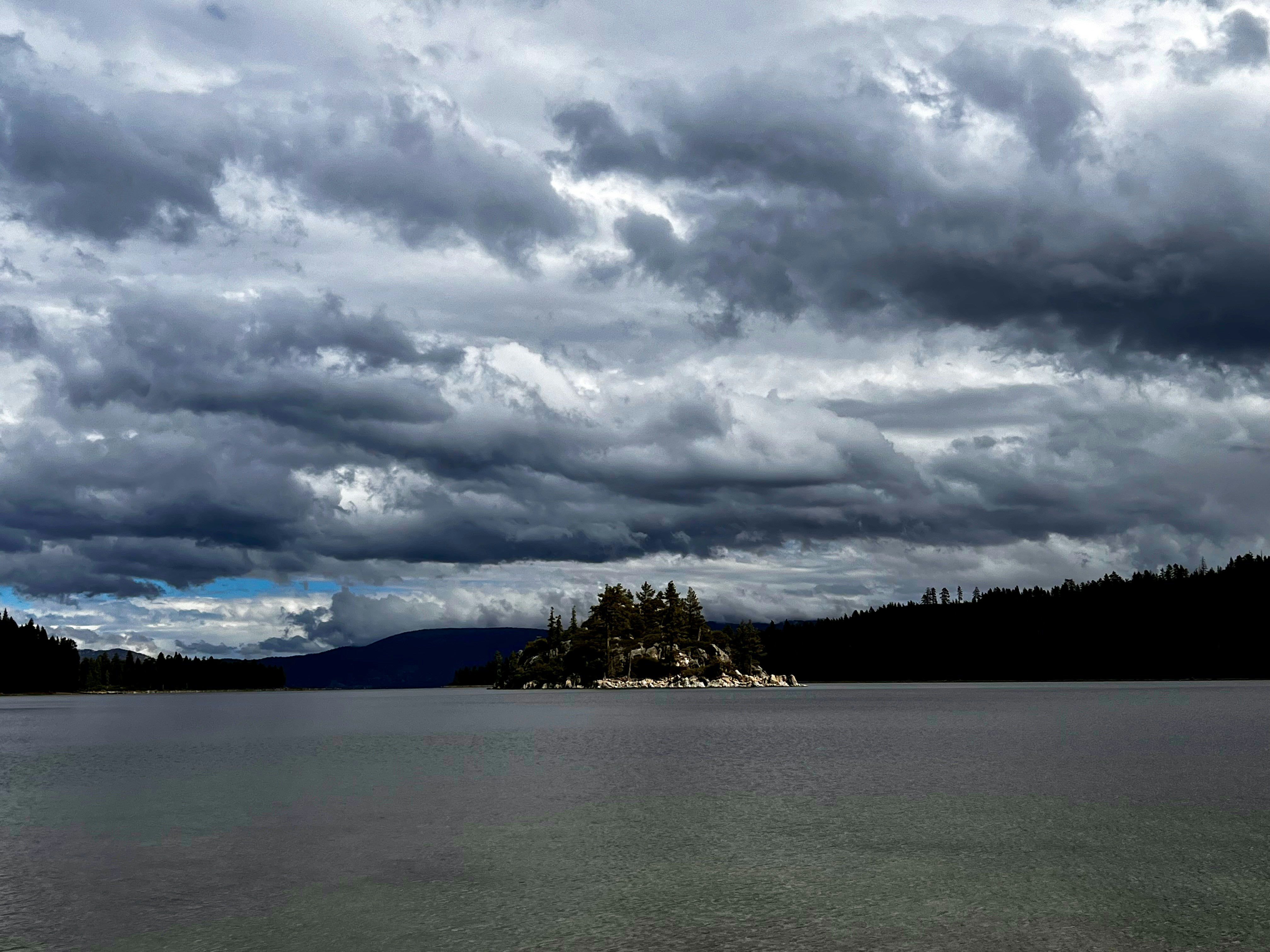 a large body of water under a cloudy sky