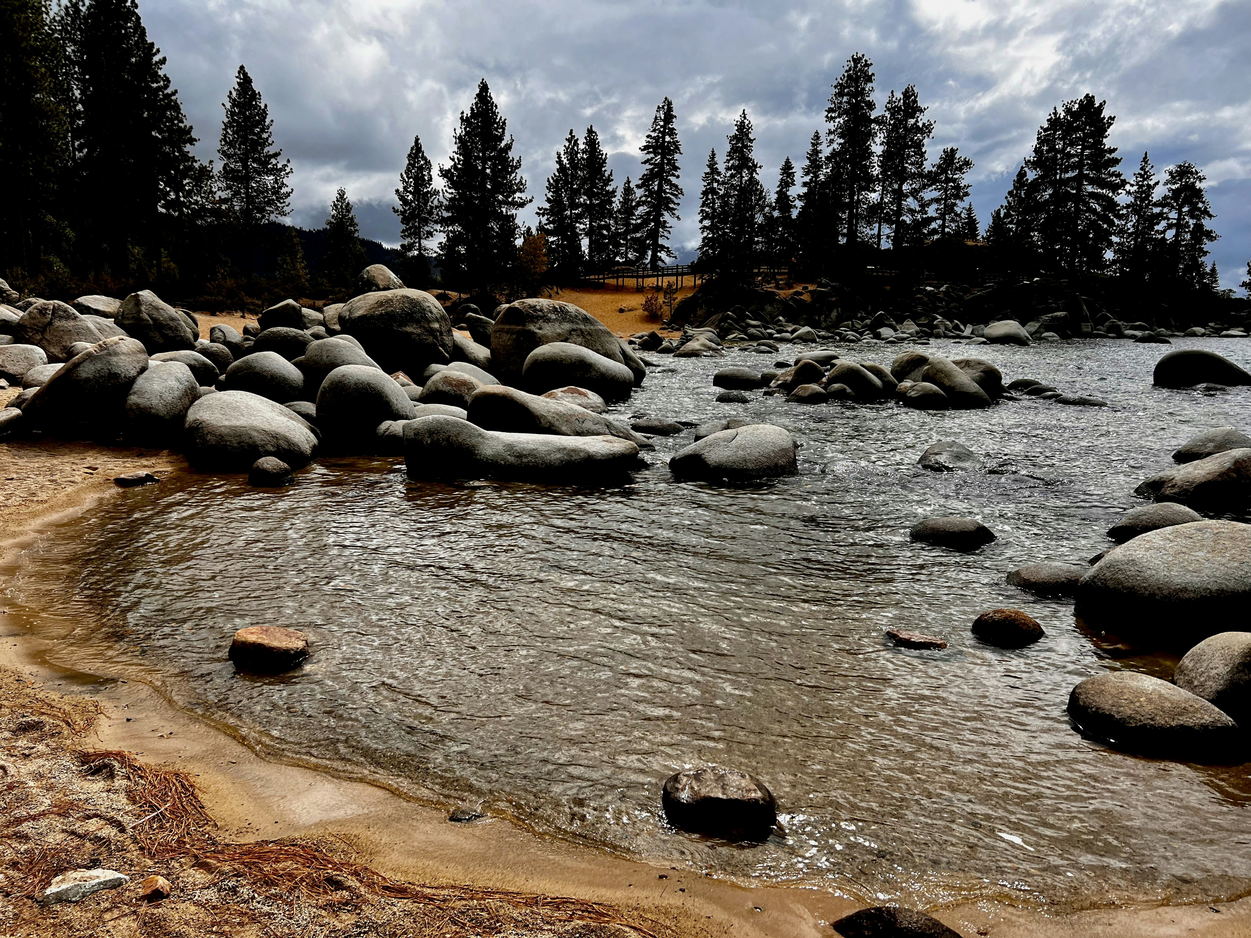 a body of water surrounded by rocks and trees